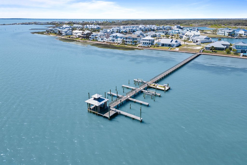 Boardwalk along St. Charles Bay with luxury homes overlooking the water