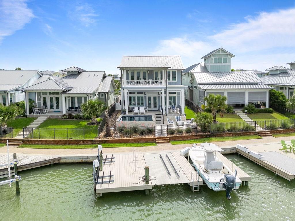 Infinity-edge pool at a luxury waterfront community overlooking the bay