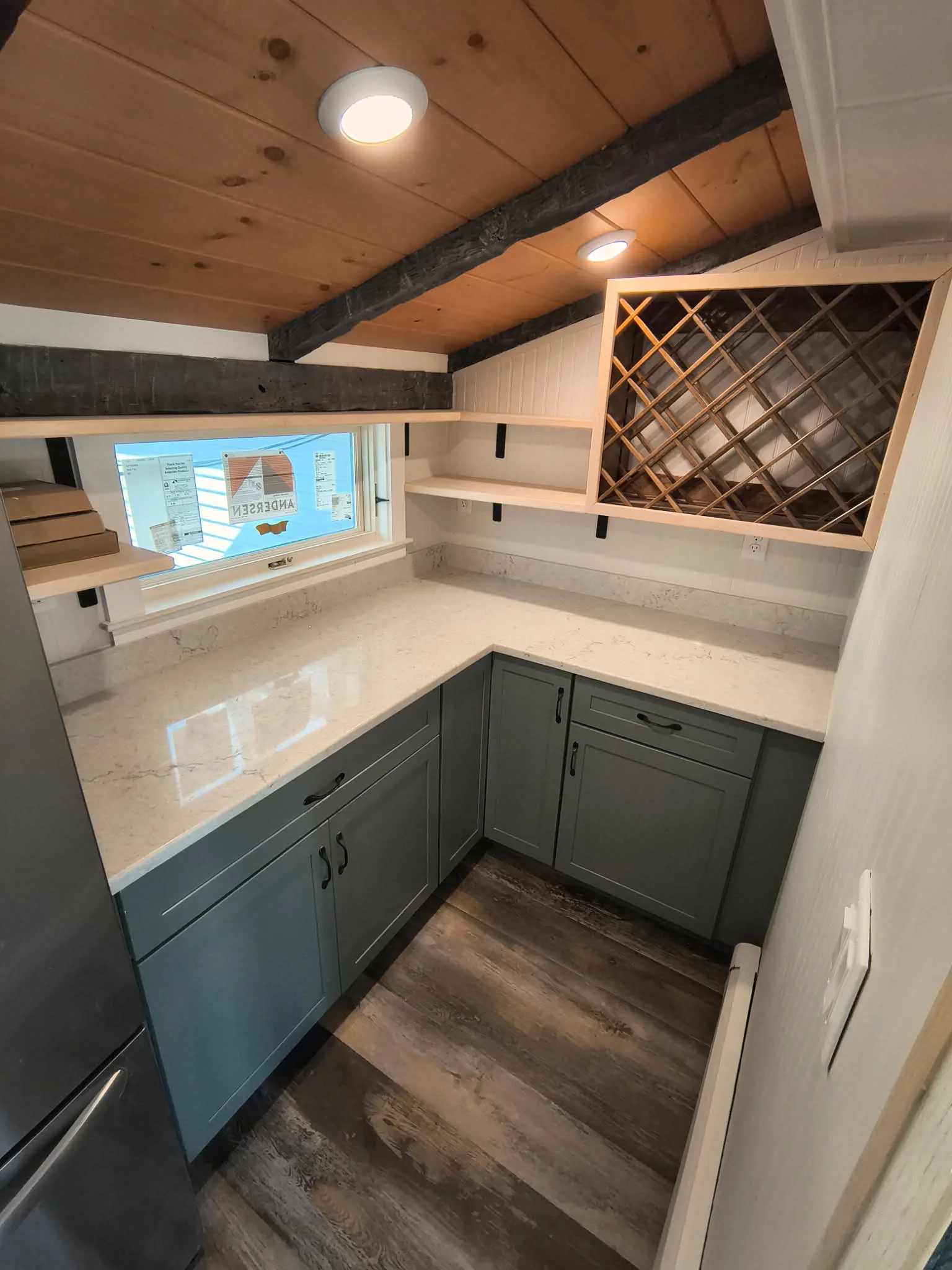 Finished basement or attic living space with warm lighting and comfortable finishes