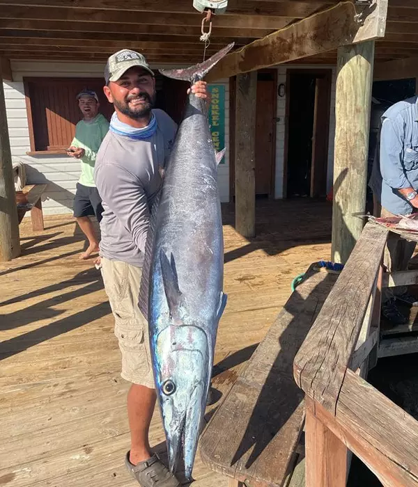 bearded man holding large fish