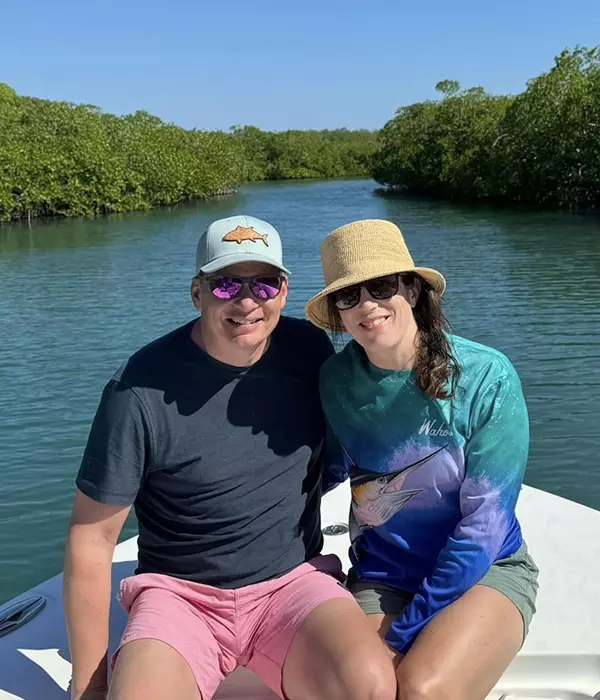 man in pink shorts and woman on a boat tour