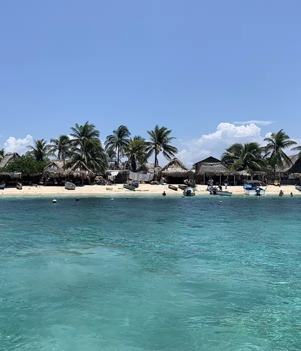 Huts on an island with clear turquoise water in front