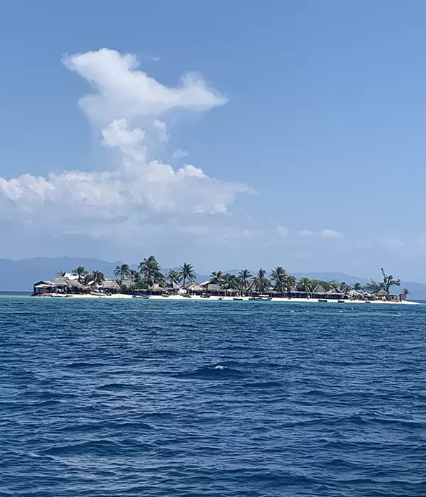 small island with huts on it in the caribbean