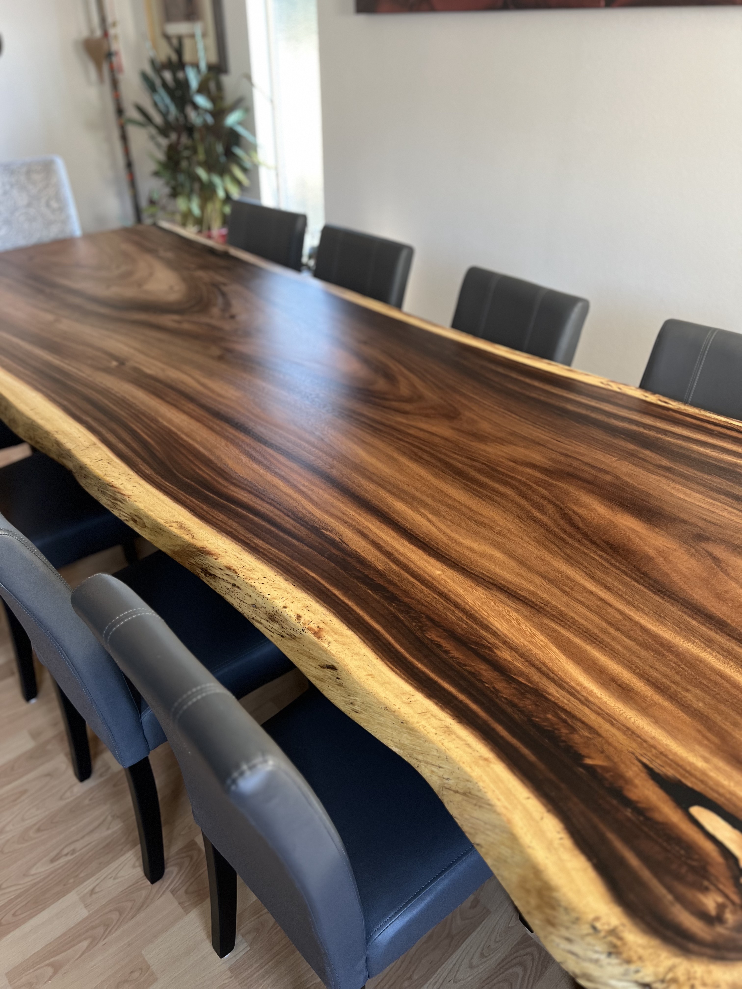Polished live edge slab showing dark heartwood against pale sapwood