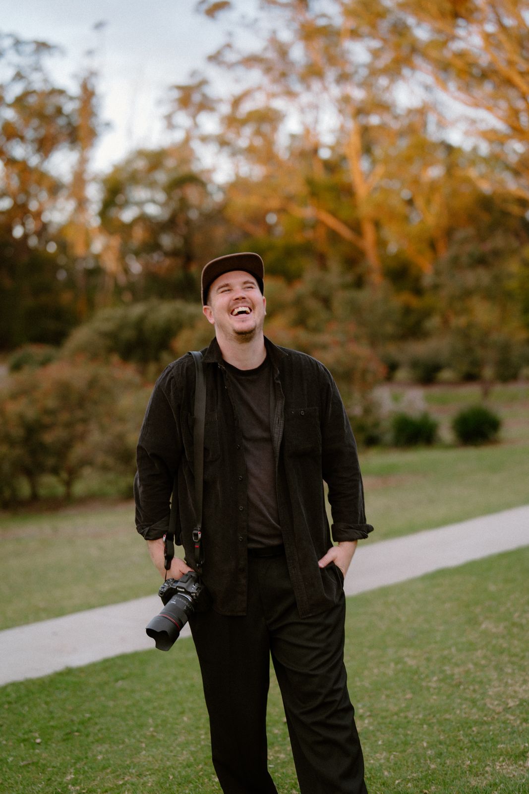 One of the crew laughing behind the camera on a wedding day