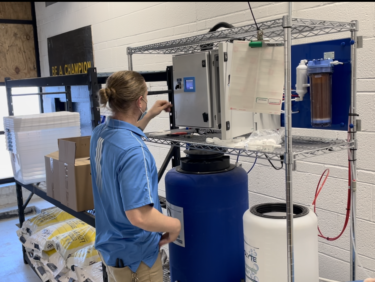 A Danolyte team member checks an HOCl generator where Danolyte Disinfectant is made fresh
