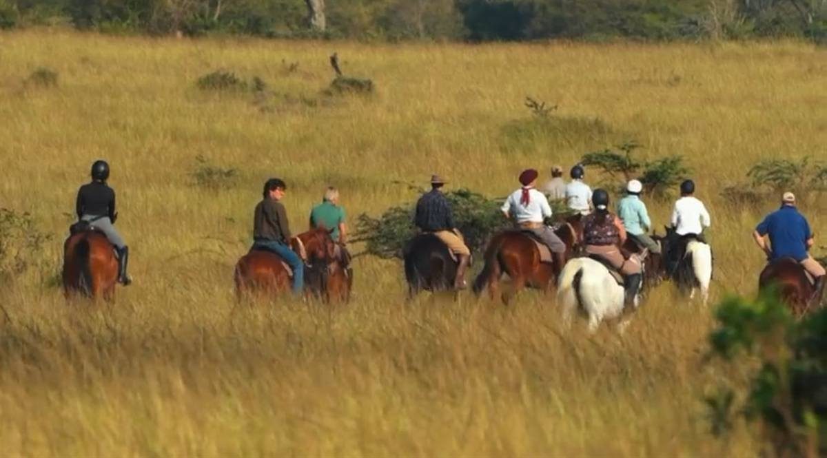 Riders crossing the open plains on horseback