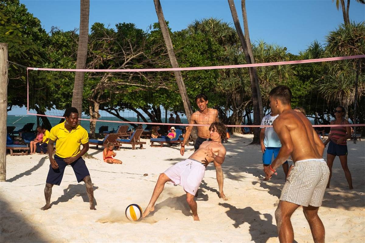 A volleyball net on the sand beside the Indian Ocean