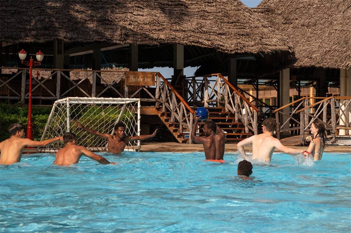 Guests playing water polo in the resort pool