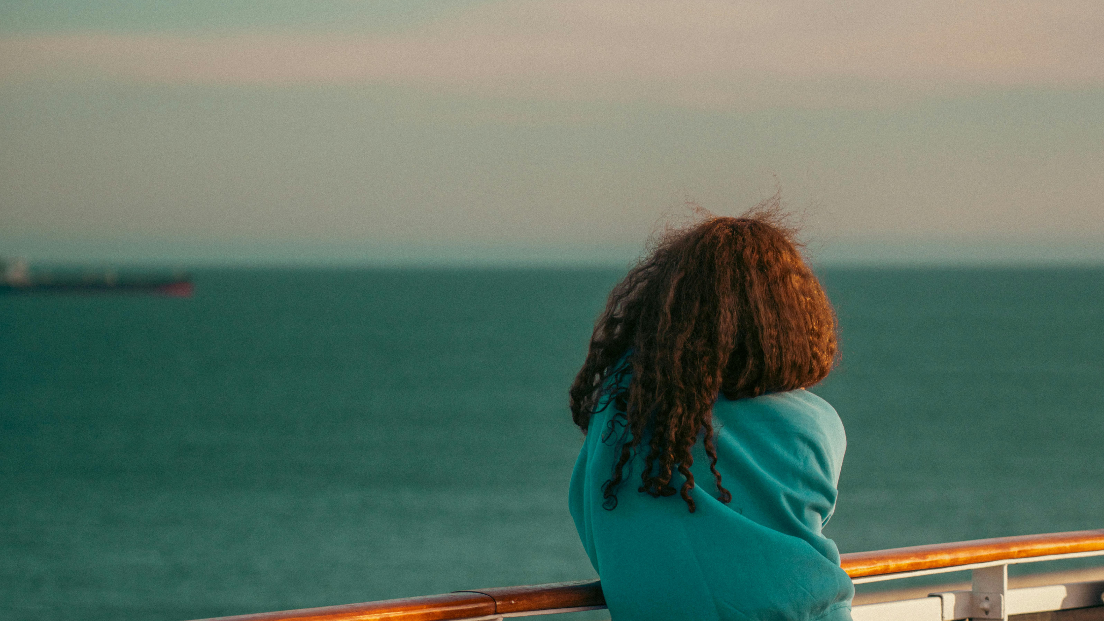 woman looking out the ocean woman looking out the ocean