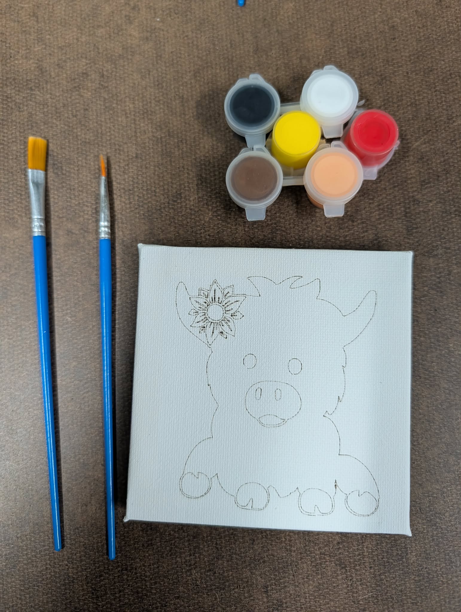 Kit contents: a 4x4 canvas pre-drawn with the baby highland cow, six paint pots, and two brushes