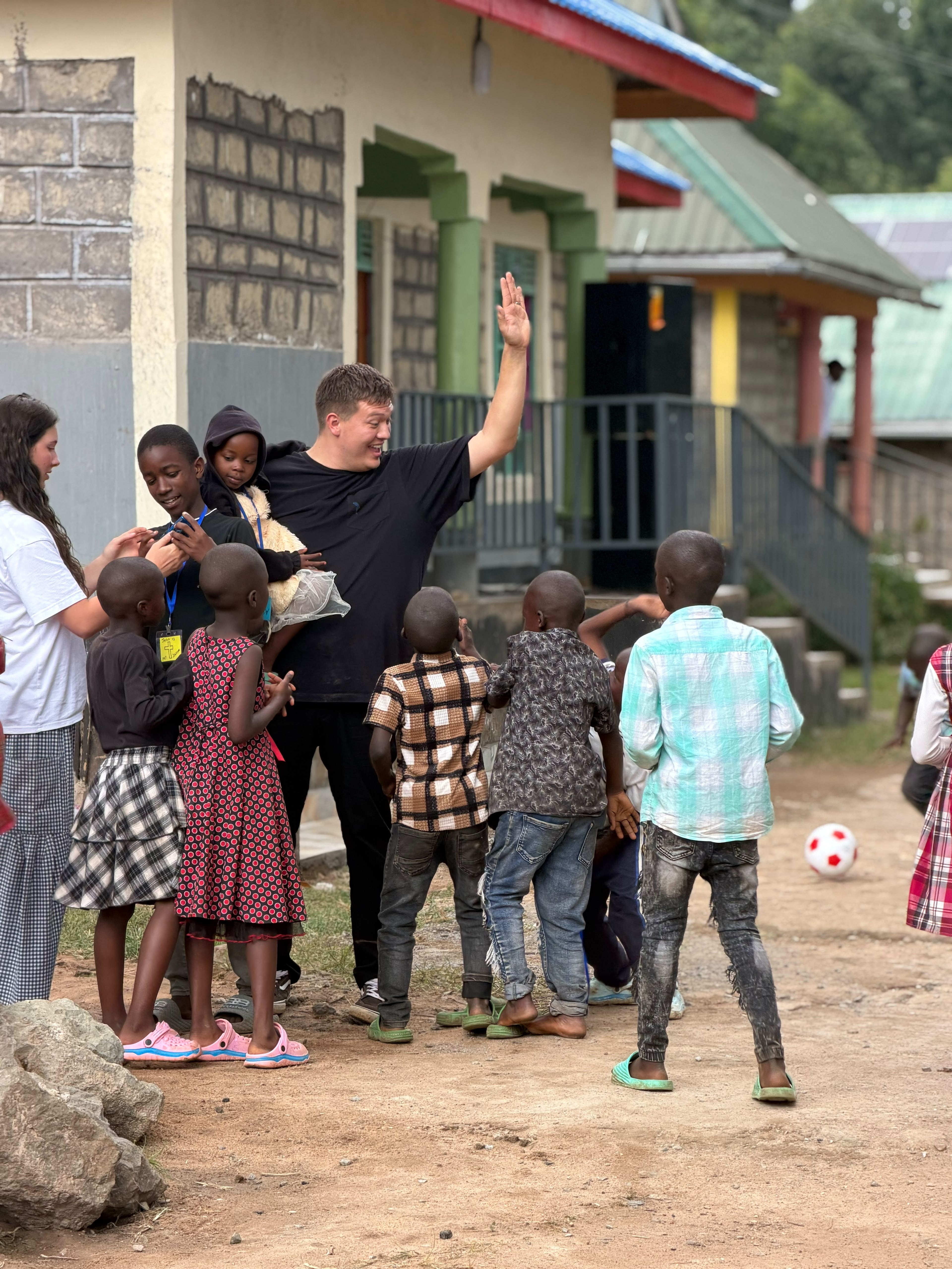 Children gathered with KOP visitors outdoors