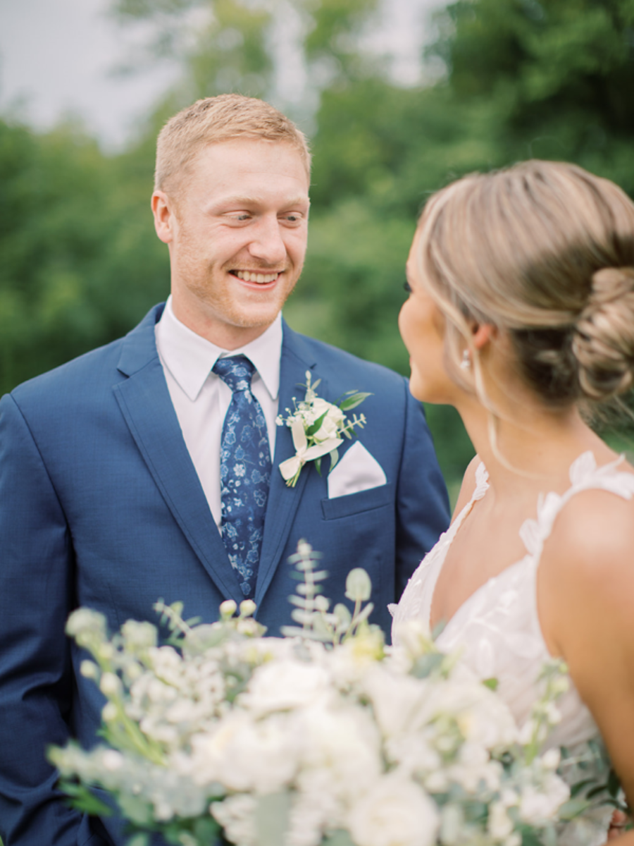 Mother of the Bride kissing Bride on the forehead while getting ready.