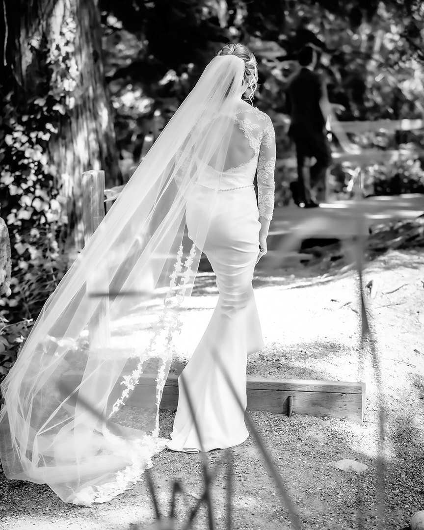 Bride walking up to where her groom is waiting for her for their first look. 