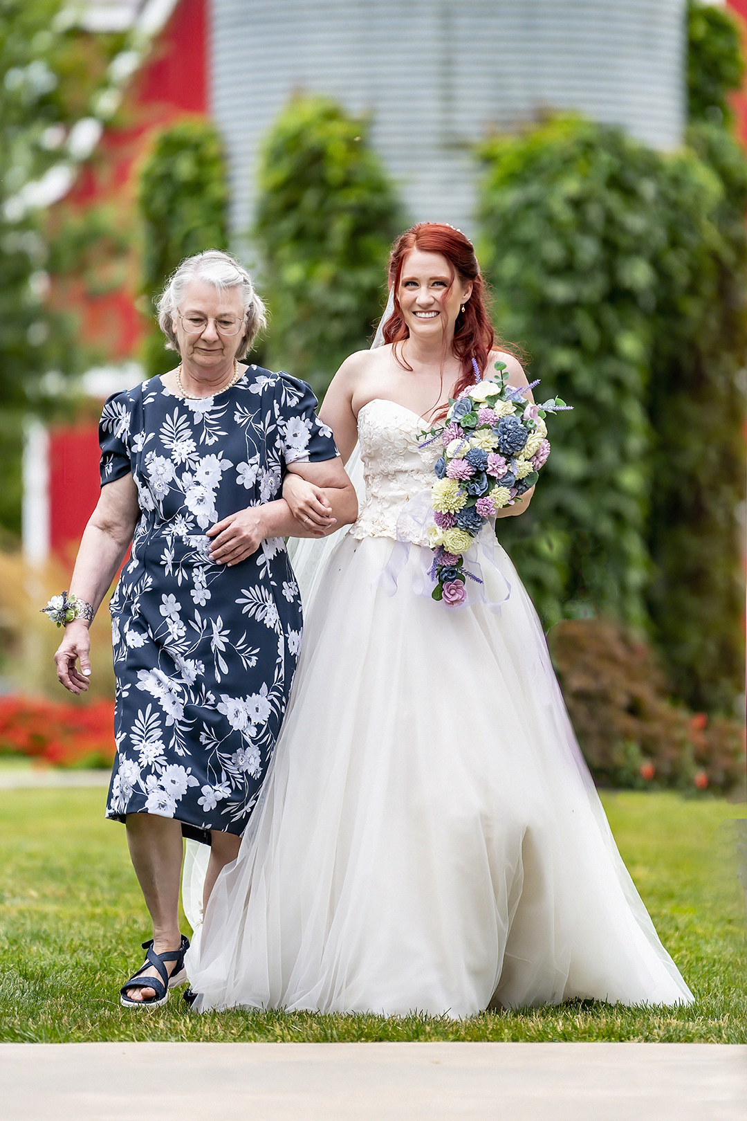 Bride walks with her mom down the aisle at Stocker Farms. 