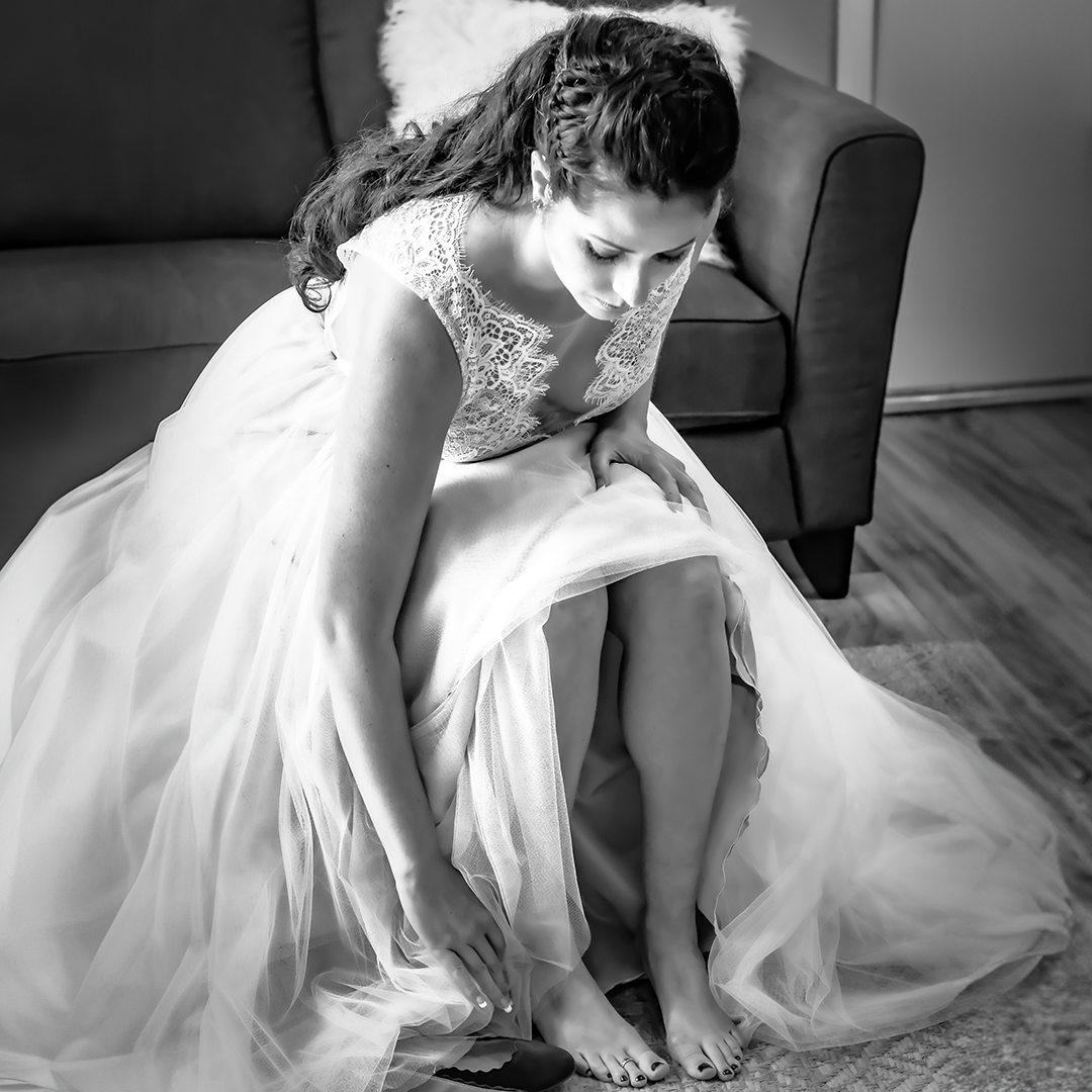 Bride getting ready in natural light during Seattle wedding morning timeline.