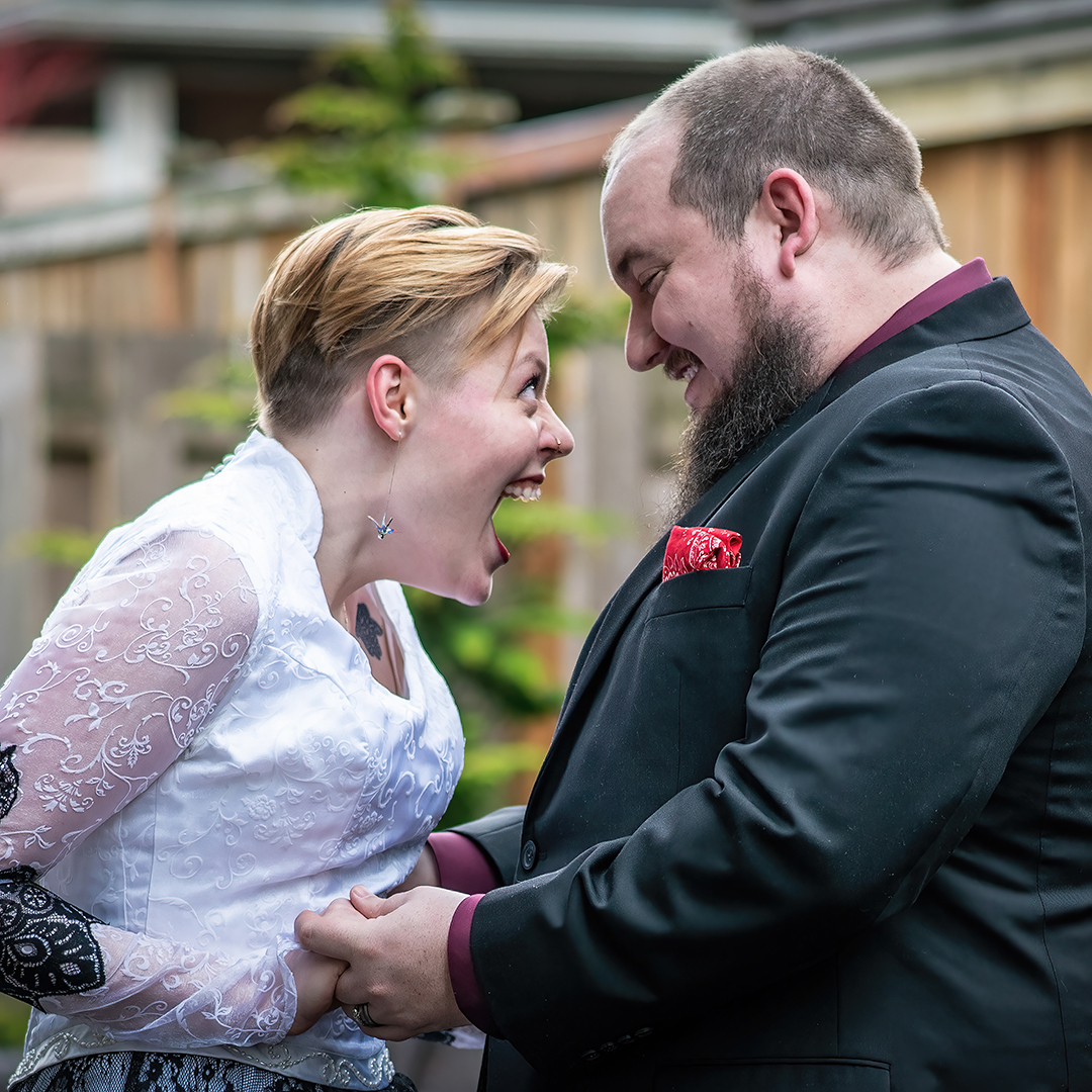 Couple laughing and enjoying their wedding day. 