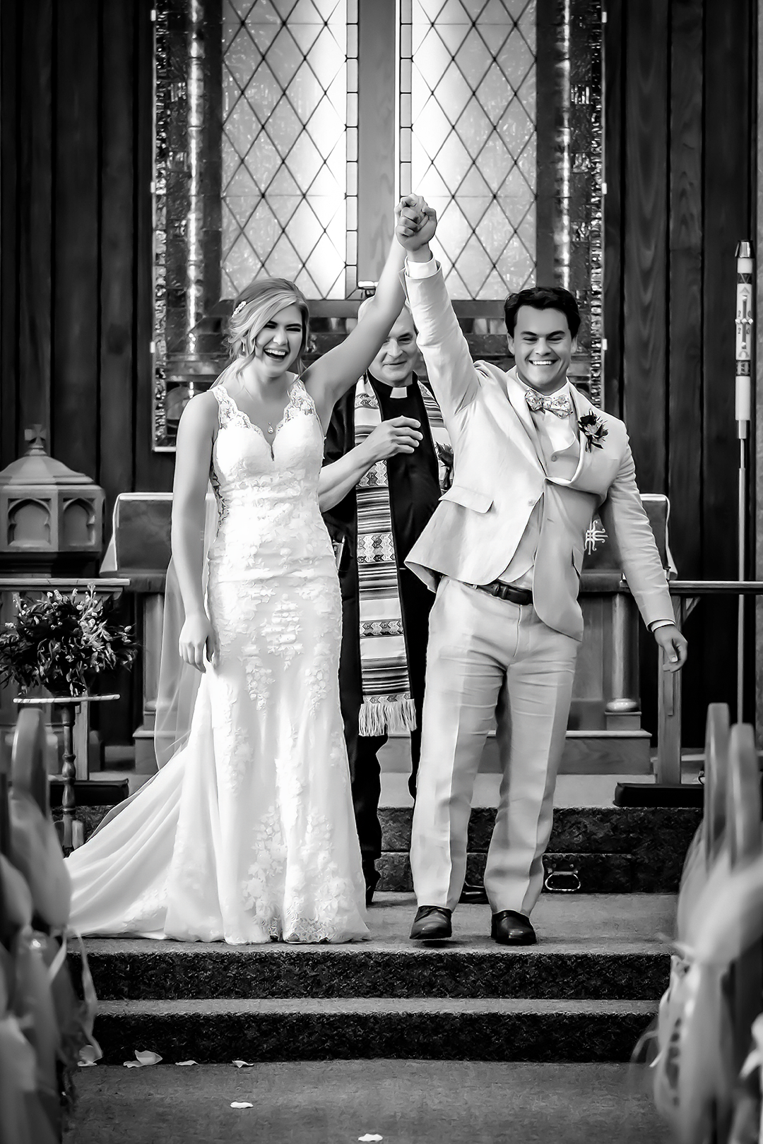 Bride and groom smile while walking hand n hand as guests toss lavender at them on their grand exit. 