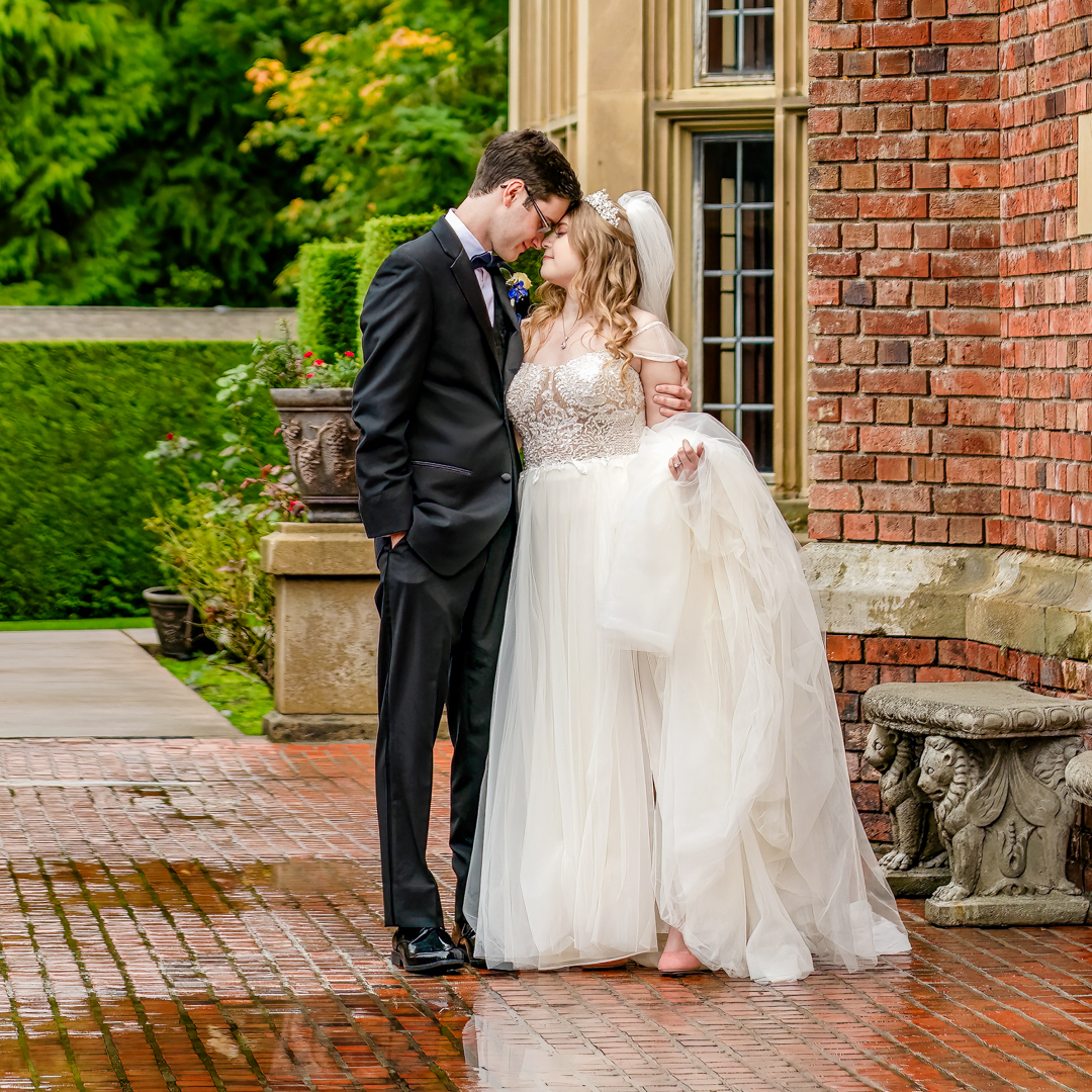 Couple stands near a puddle during their effortless portraits.