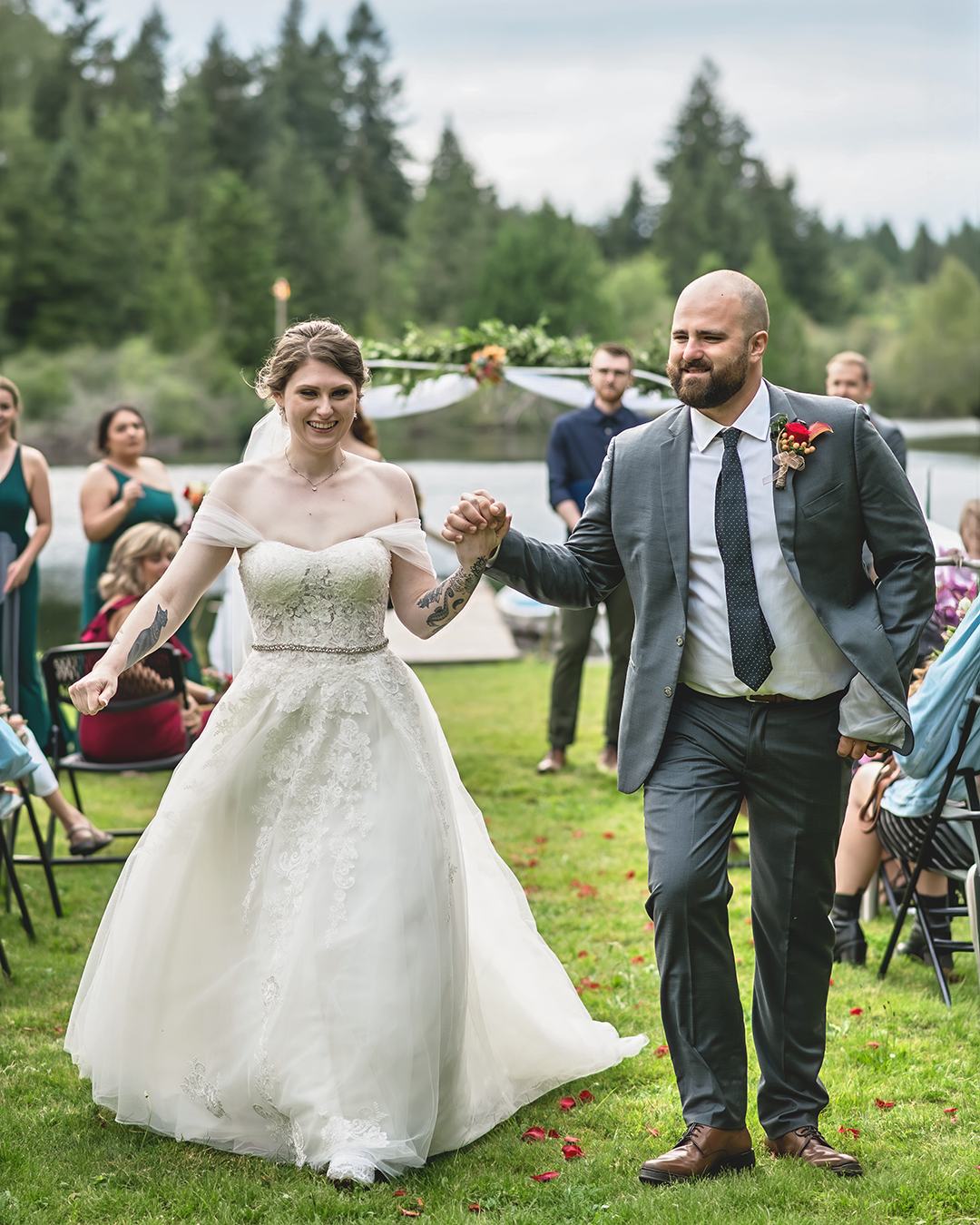 Couple exits the ceremony hand in hand while Maple Valley wedding photographer, Adina Stiles captures the moment.