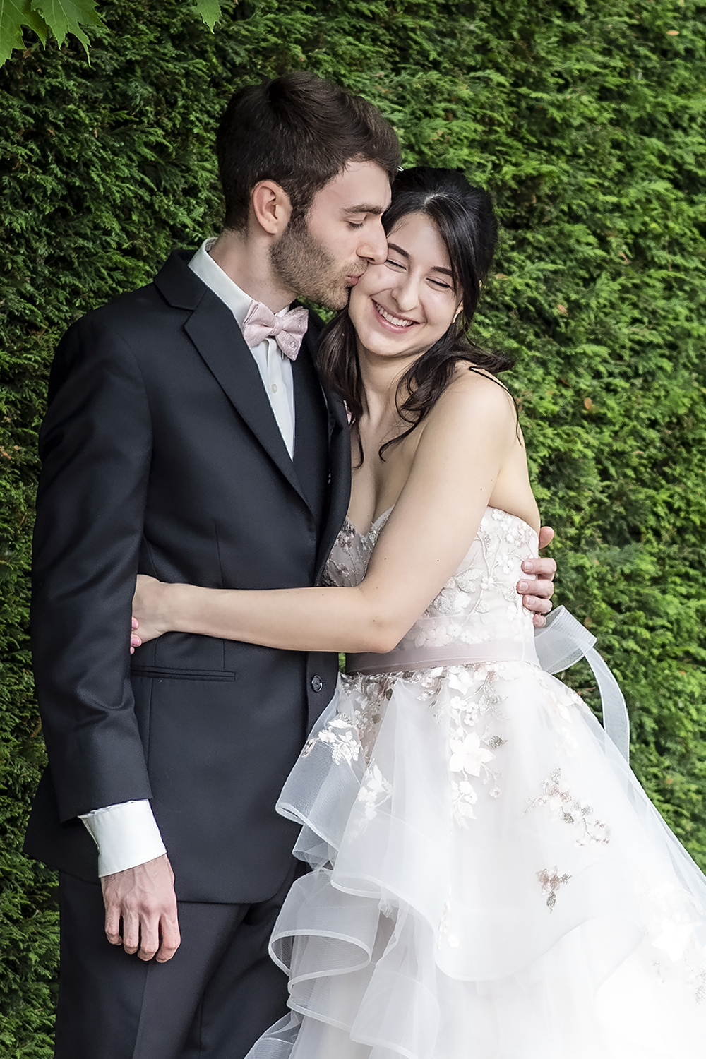 Couple cuddles at the Willows Lodge on their wedding day. 