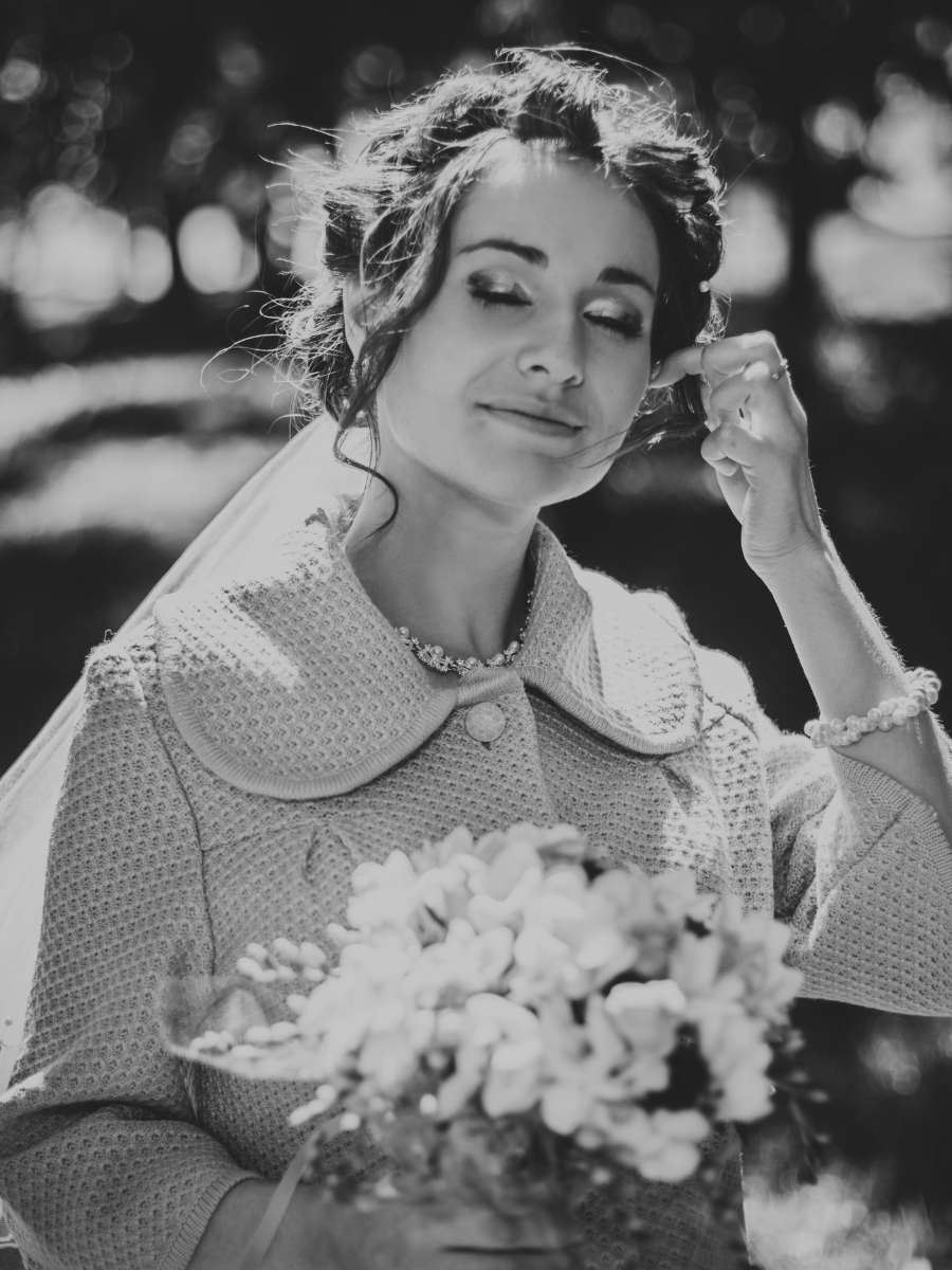 Bridal couple kissing. Man lifts woman hand and kisses it.