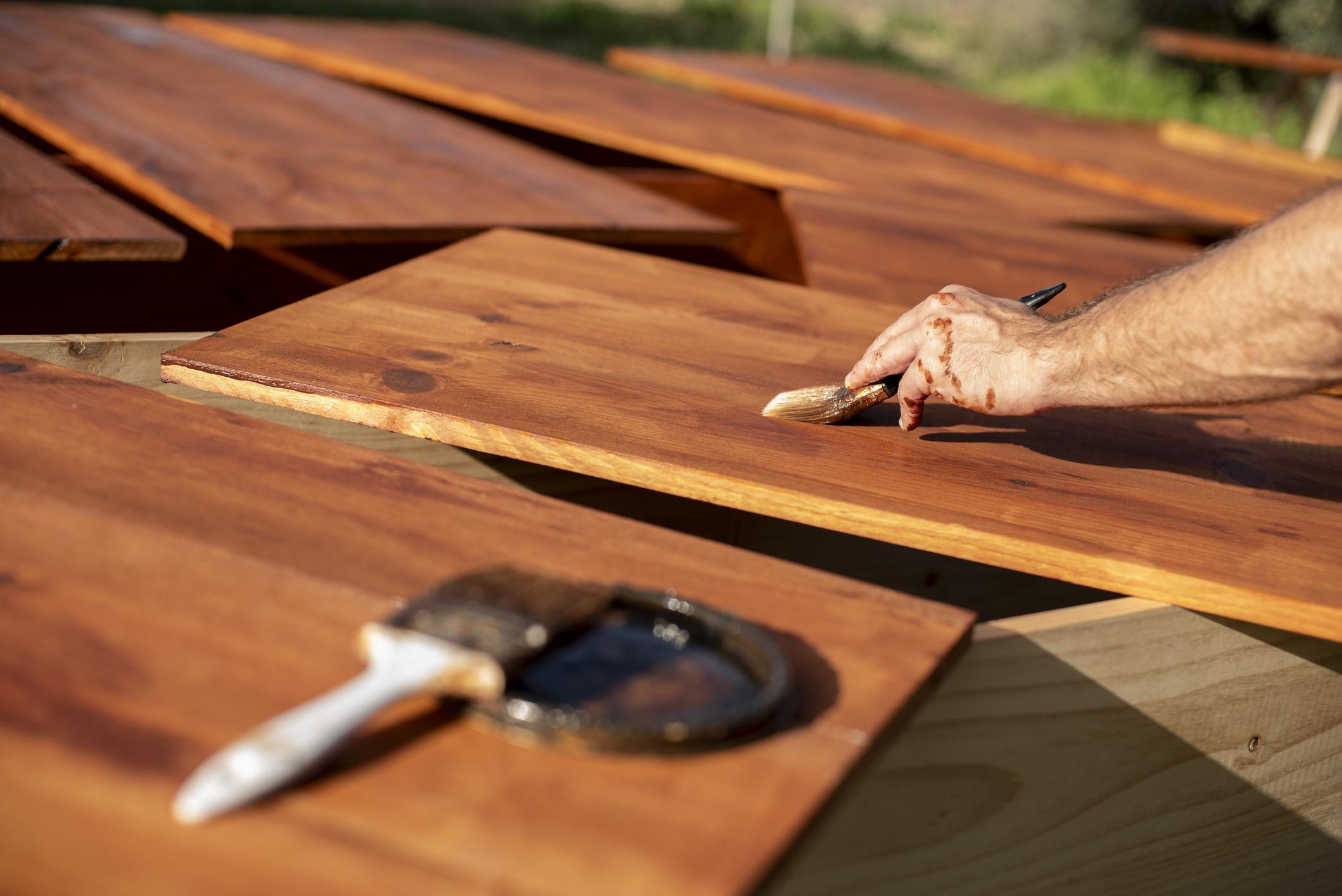 Applying wood stain to fence boards for long lasting protection