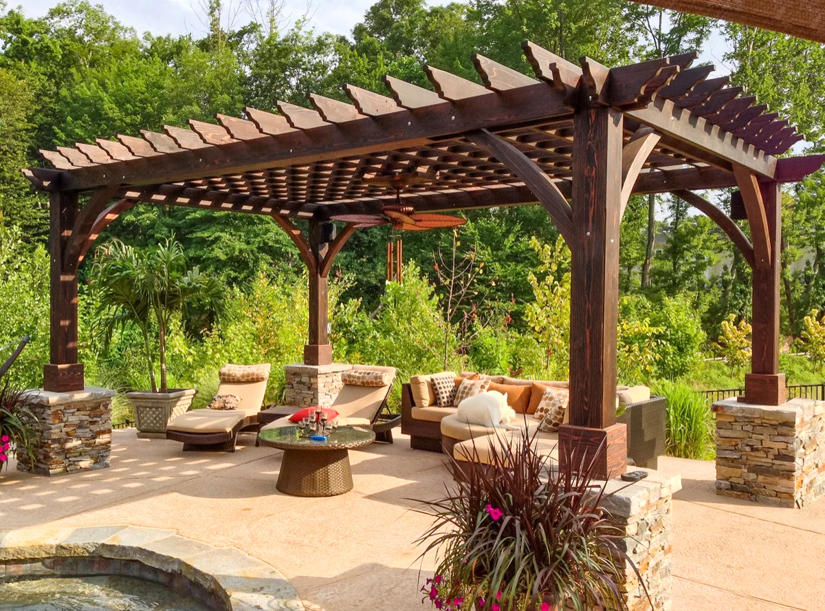 Professional pergola staining process applying wood stain evenly for long-lasting protection