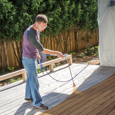 Deck staining process including power washing, drying, and applying wood stain for protection