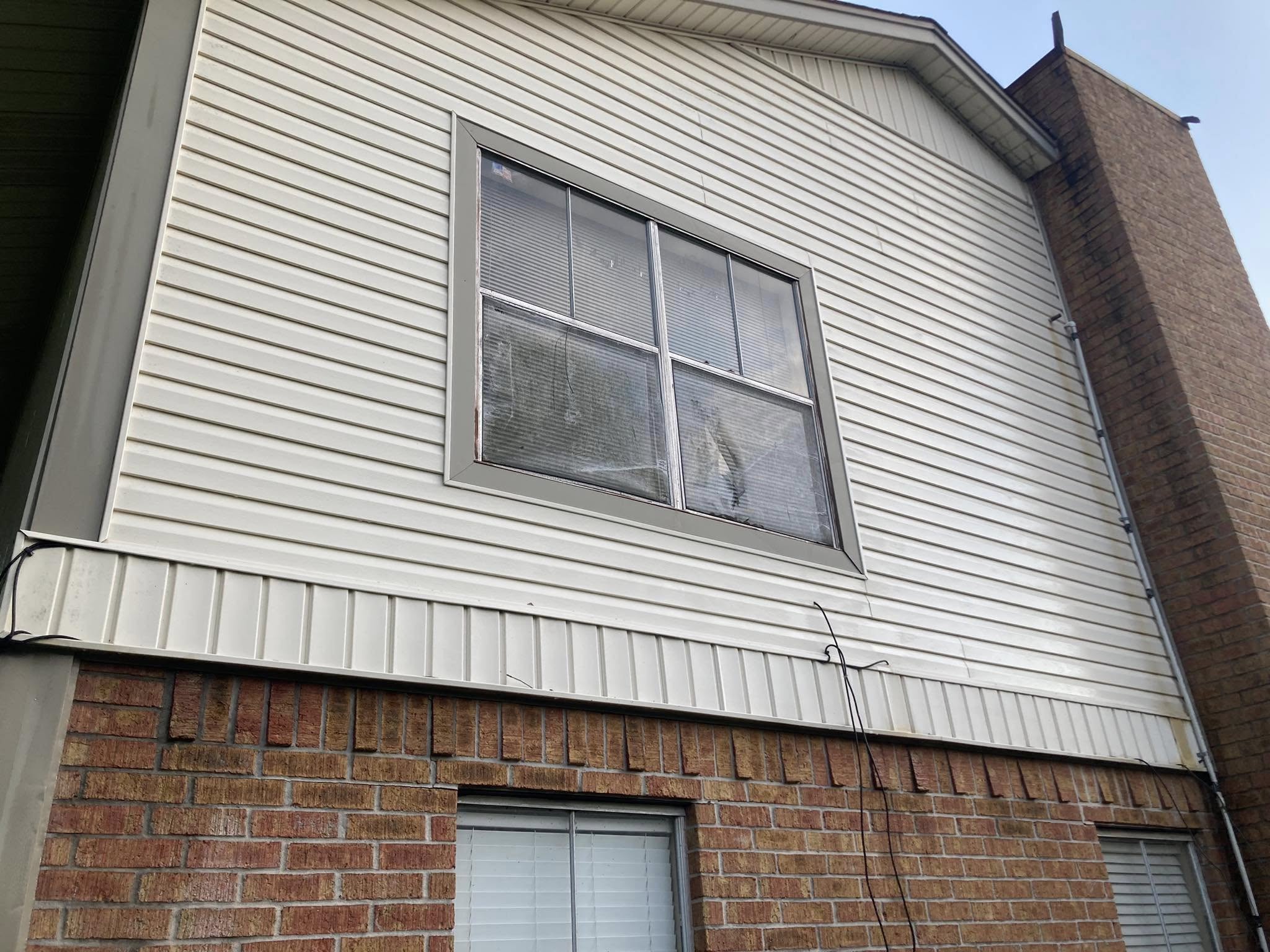 House washing results showing restored siding color