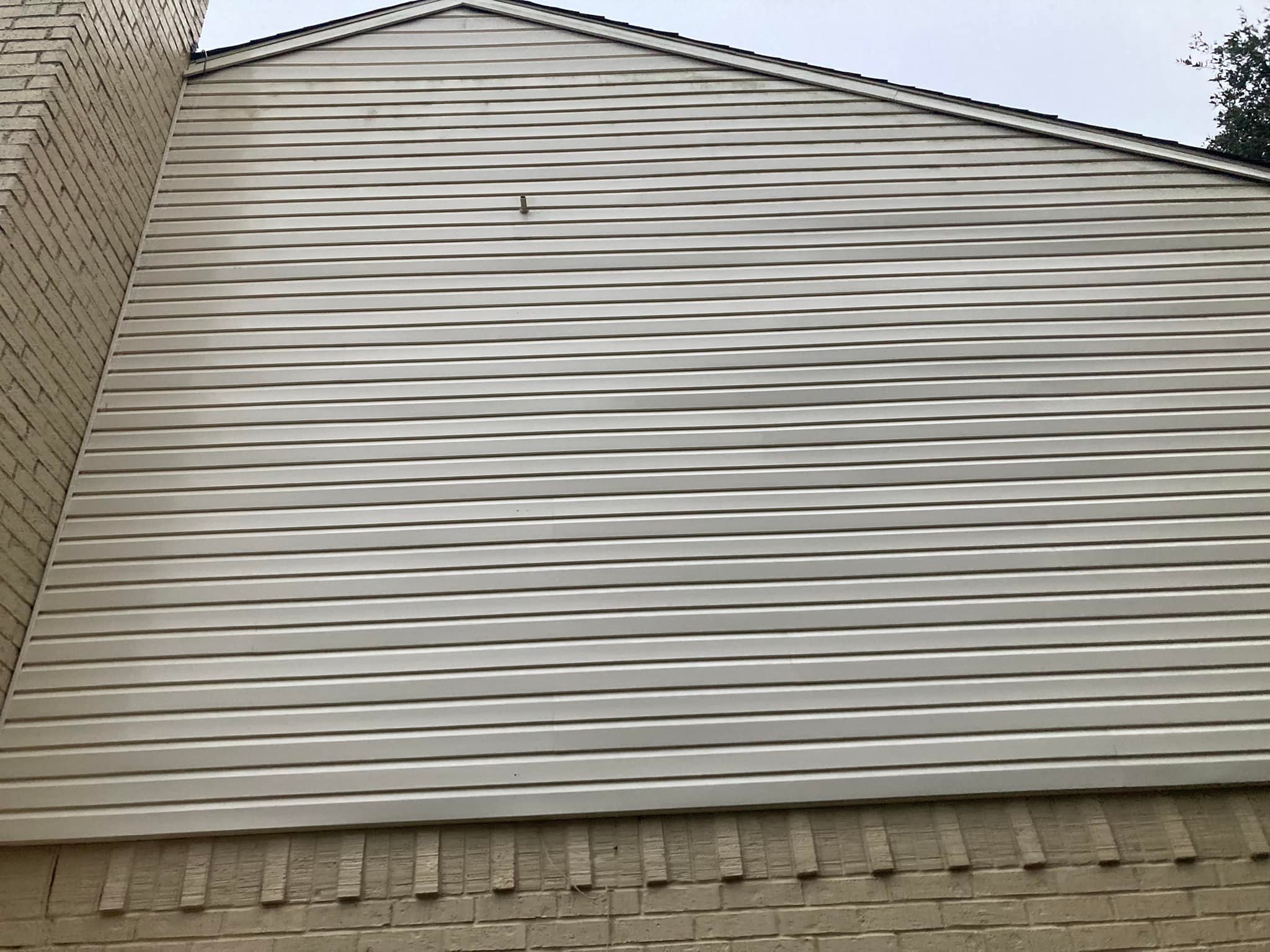 Freshly washed house exterior with restored vinyl siding