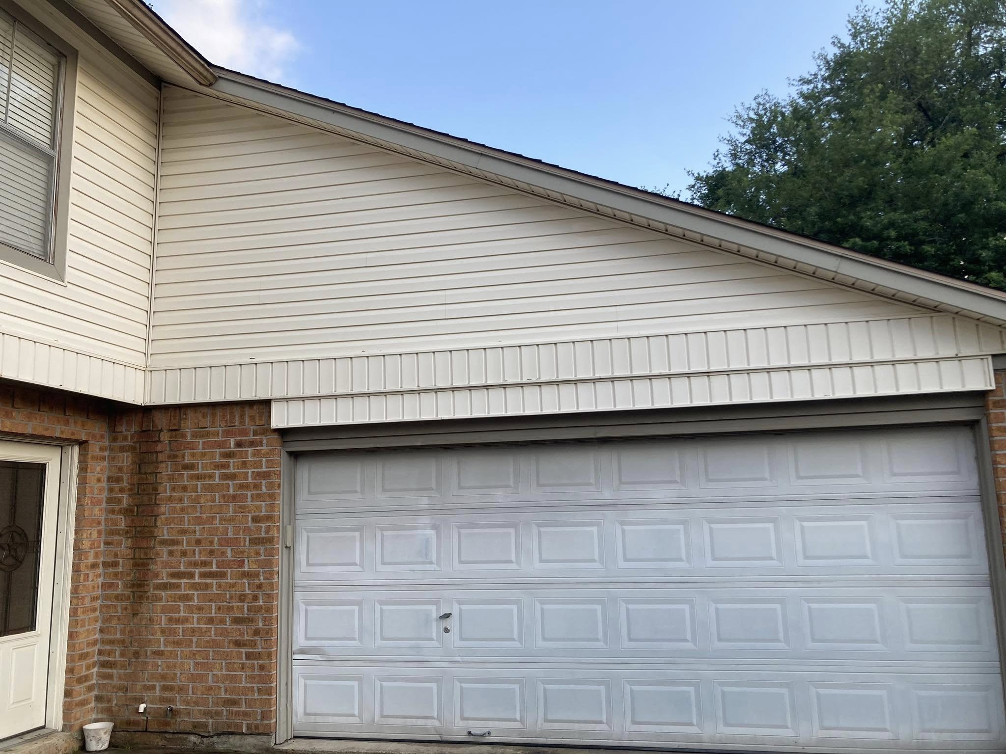 Pressure-washed two-story home with clean siding in the Houston Bay Area