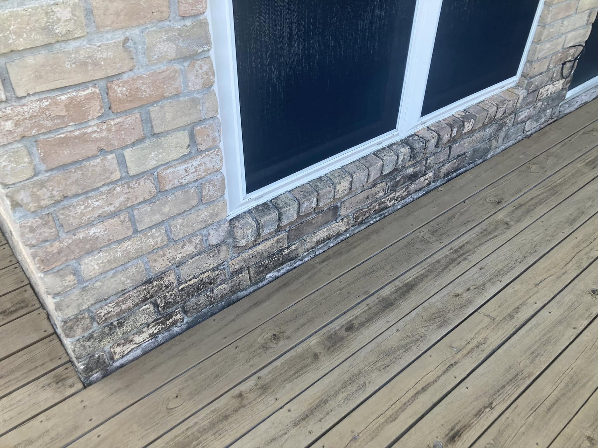 Wooden deck before pressure washing, covered in grime and oxidation