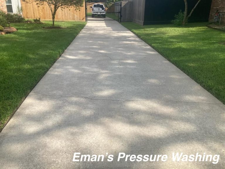 Pressure-washed driveway showing restored concrete color