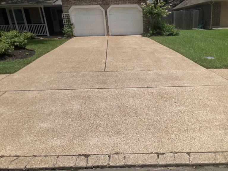 Driveway after pressure washing with like-new surface