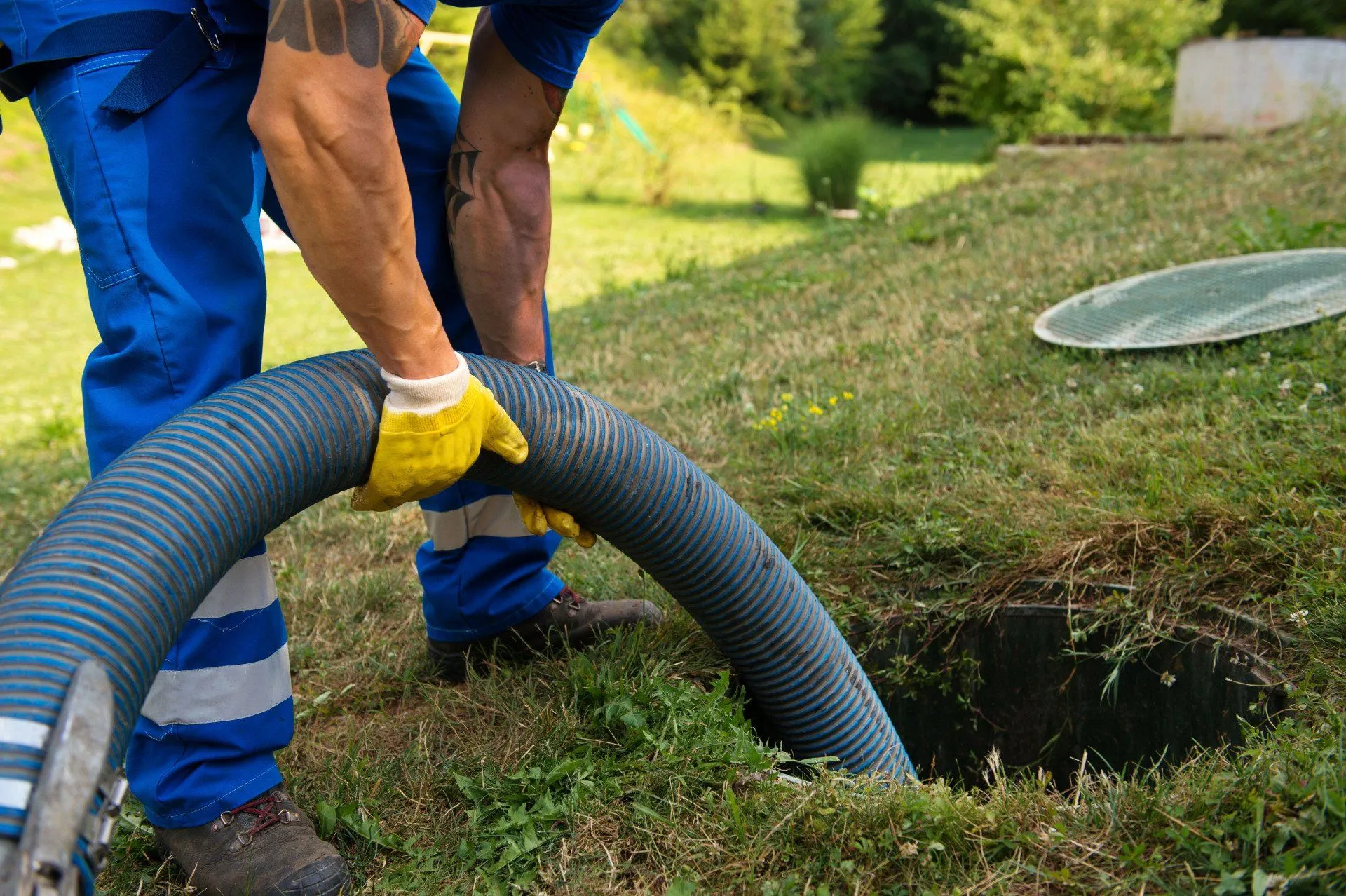 Technician cleaning residential septic tank