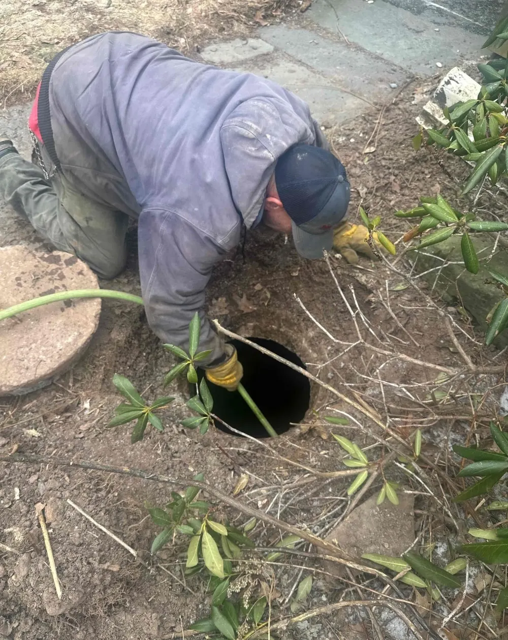 technician using high pressure hydro jetting equipment to clean drains