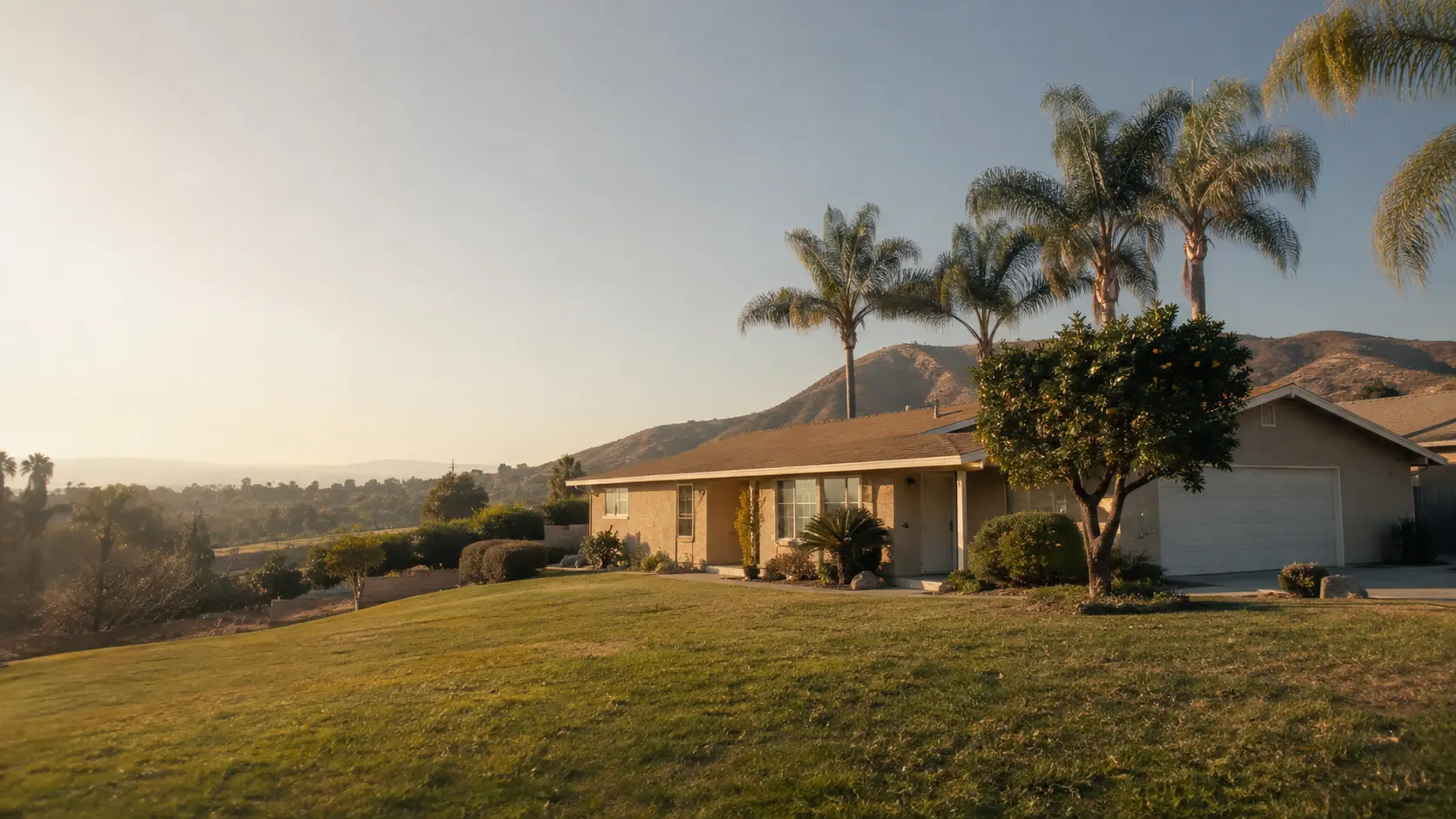 Single-story ranch home with palm trees and the Box Springs Mountains in Riverside, California
