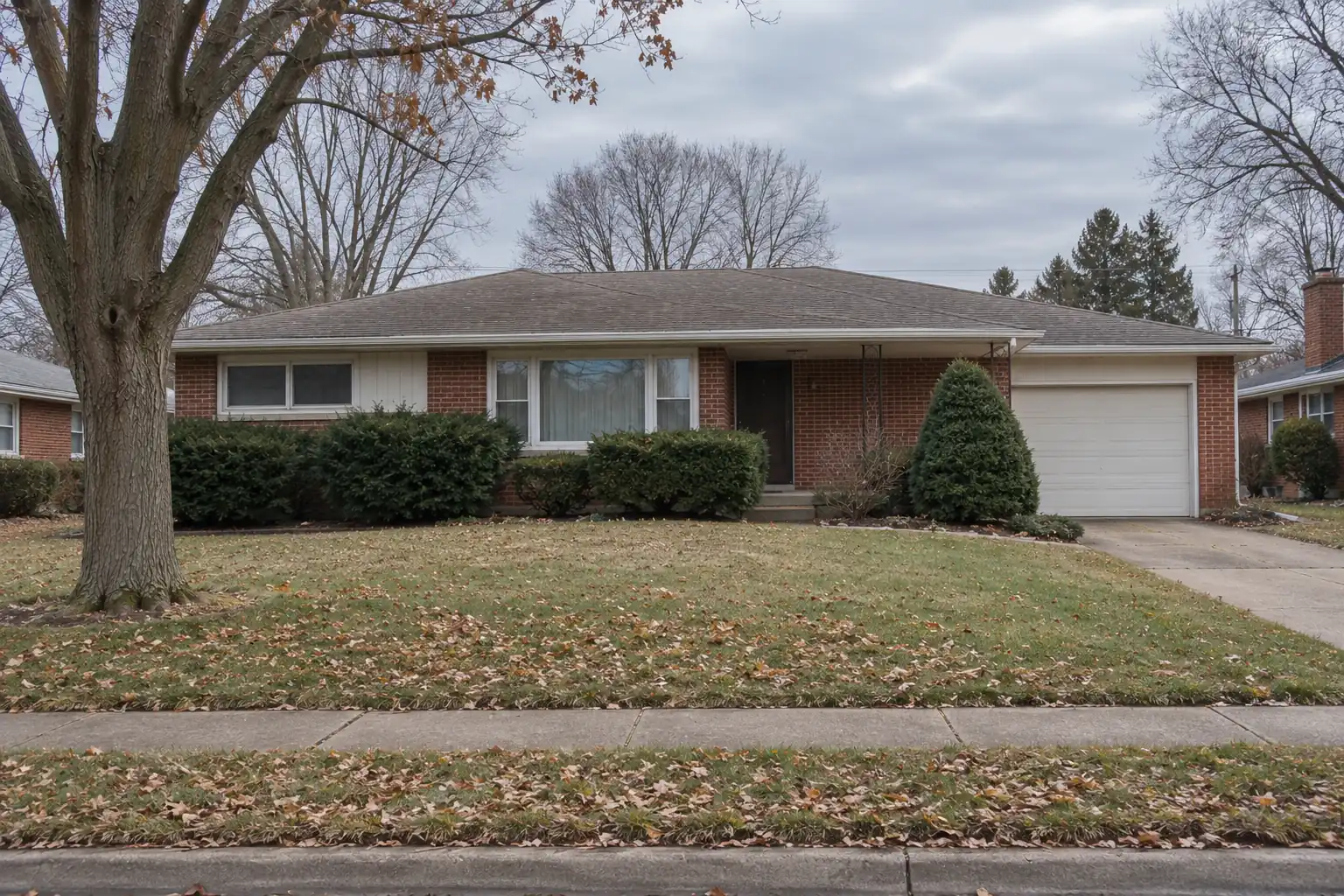 Brick ranch house in Parma Heights, Ohio with an attached garage and mature maple on a wider suburban lot