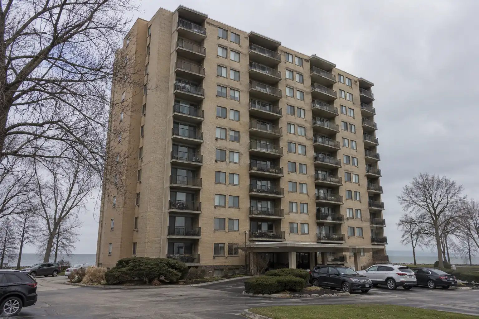Mid-century buff brick lakefront condominium tower with projecting balconies on Lake Erie in Lakewood, Ohio