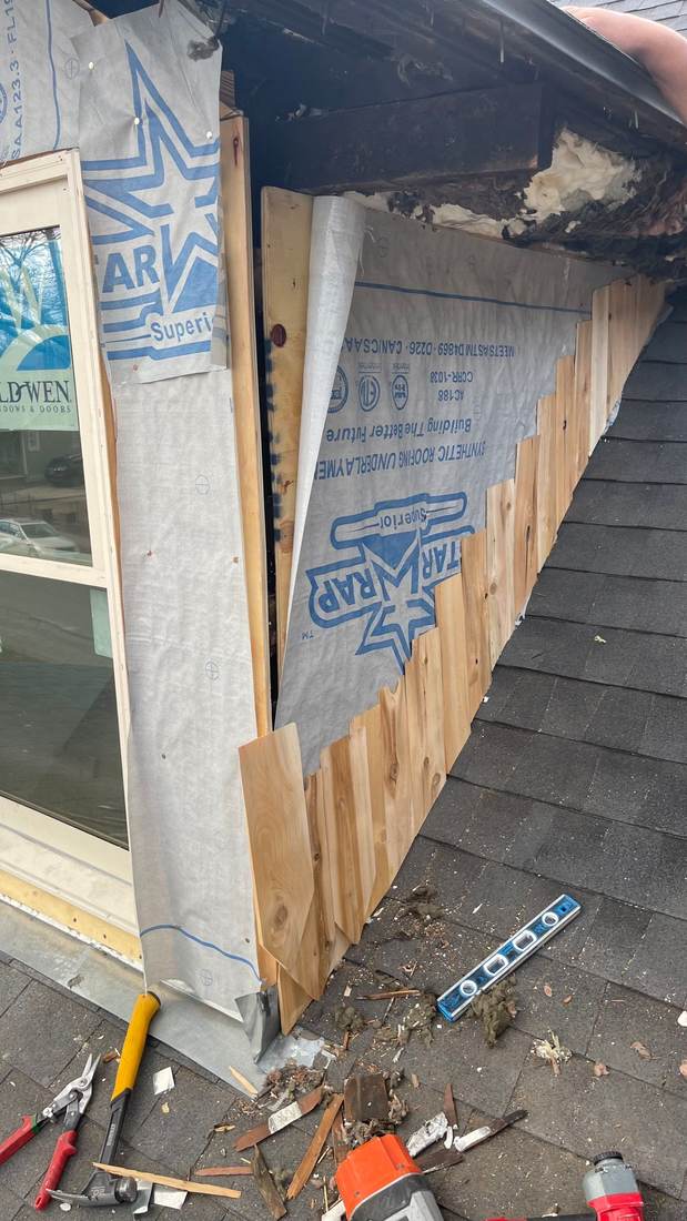 Custom-milled wood siding boards being installed over house wrap on a historic home in Fort Worth