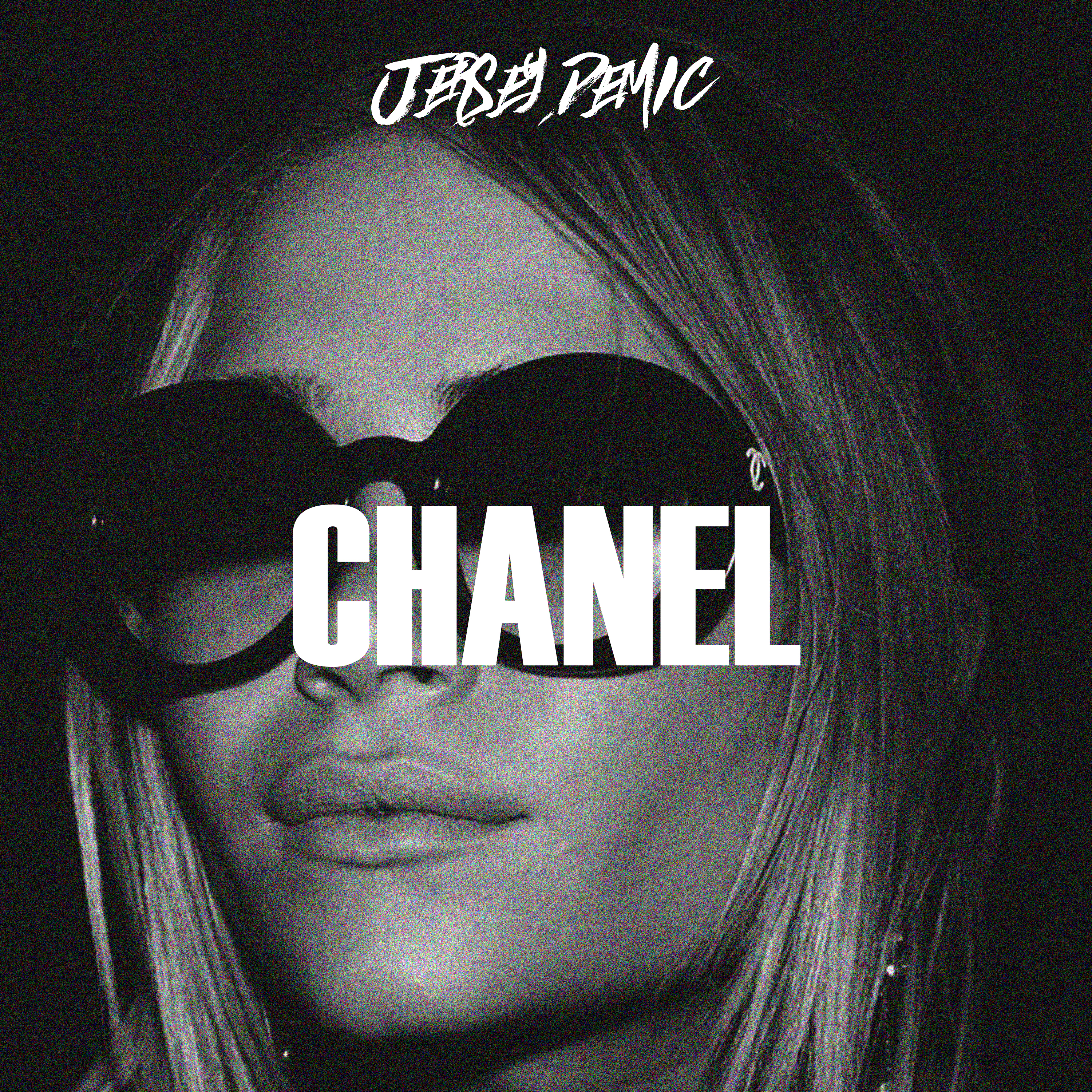 Close-up of a woman wearing oversized sunglasses with the word "CHANEL" prominently displayed, reflecting a stylish and chic aesthetic relevant to Danny Adivo's creative branding and digital media focus.