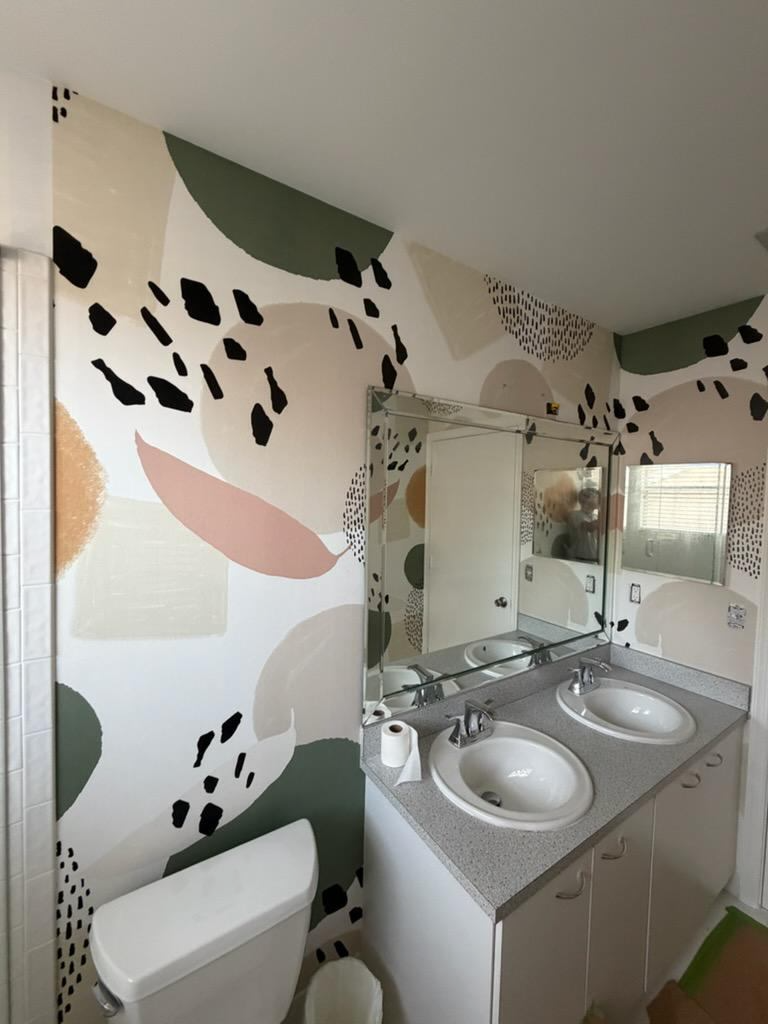 Renovated bathroom with custom abstract wall finish