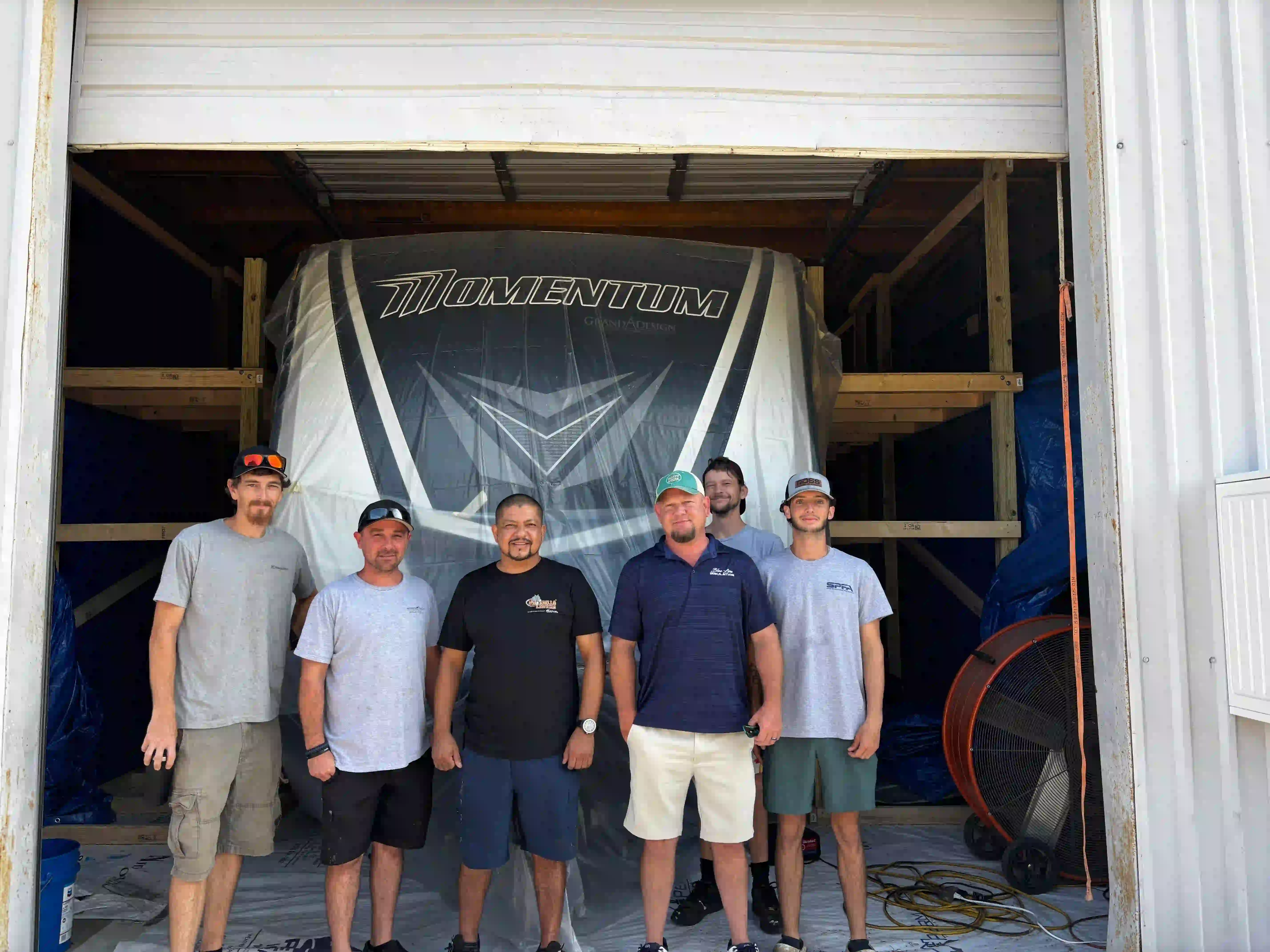RV Coatings of Florida team in Panama City FL standing in front of RV prepared for premium roof coating
