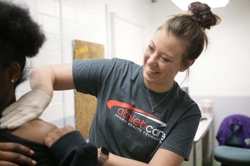 Athleticare athletic trainer with an athlete