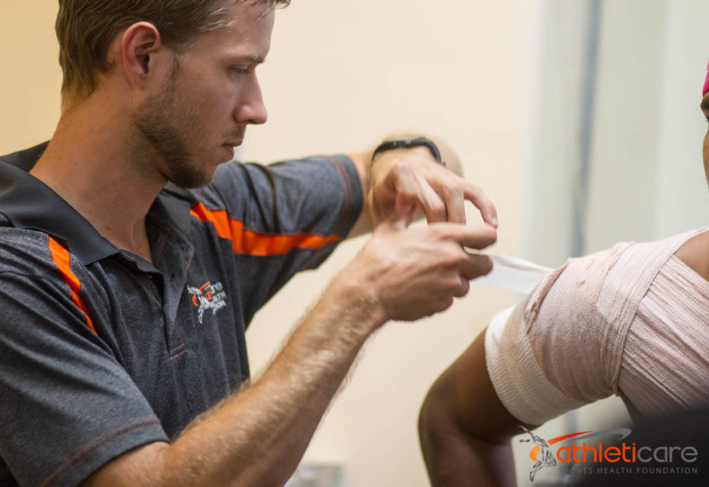 Athletic trainer at a high school game