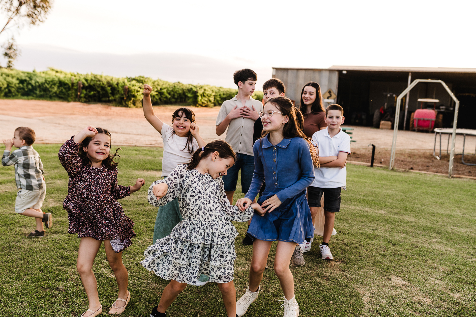 grandchildren dancing on the grandparents' rural property. grandchildren dancing on the grandparents' rural property.