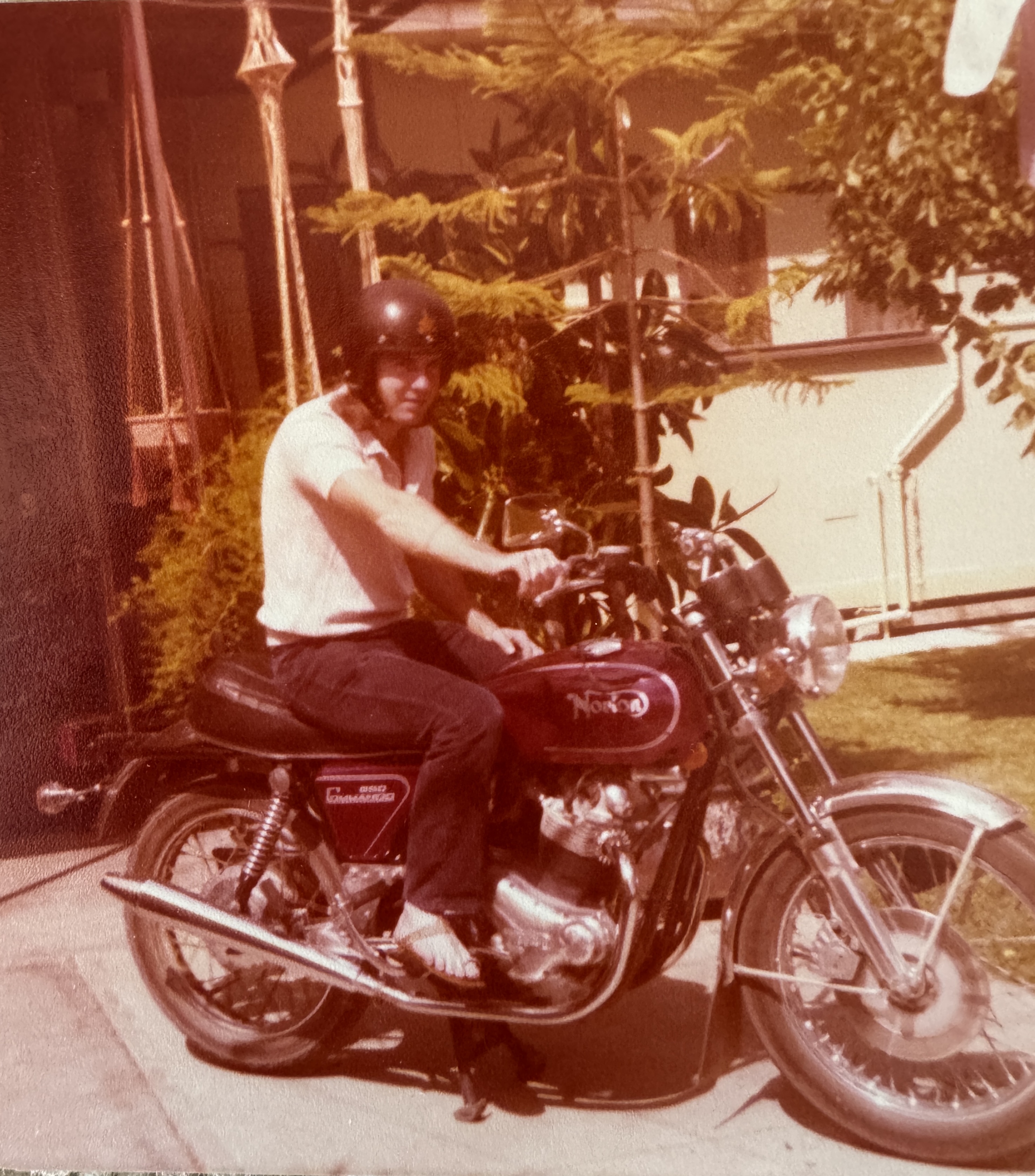 Faded 1970s photo of a teenage boy sitting on a red Norton motorcycle in a driveway, wearing a helmet and t-shirt — a snapshot from before life took its turns, part of a blog on why you never get to choose when the photos stop. Faded 1970s photo of a teenage boy sitting on a red Norton motorcycle in a driveway, wearing a helmet and t-shirt — a snapshot from before life took its turns, part of a blog on why you never get to choose when the photos stop.