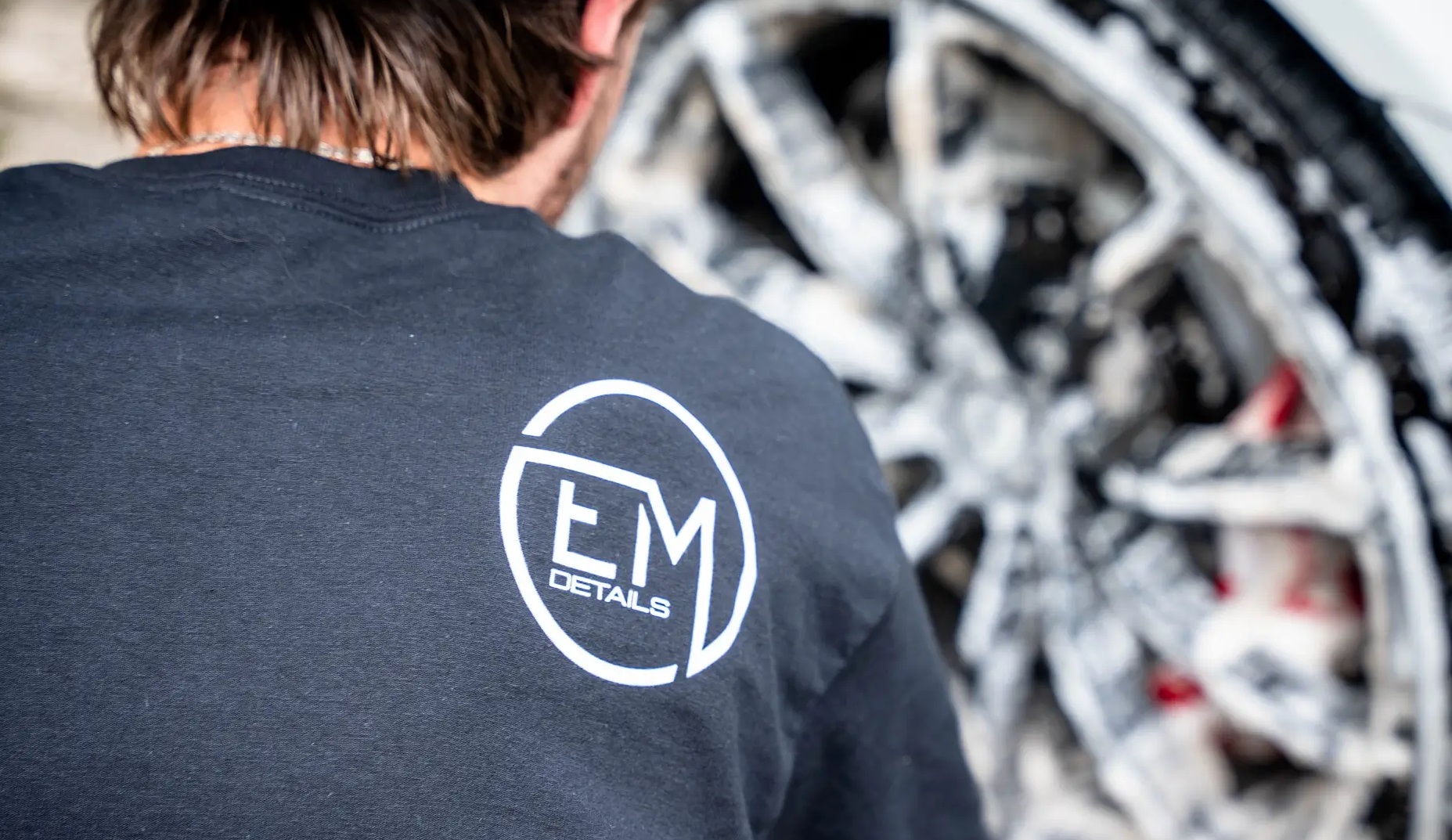 EM Details technician working on vehicle