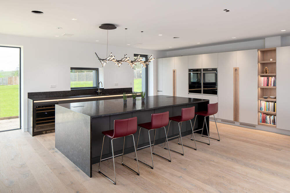 Large kitchen with waterfall island, fitted in three slabs